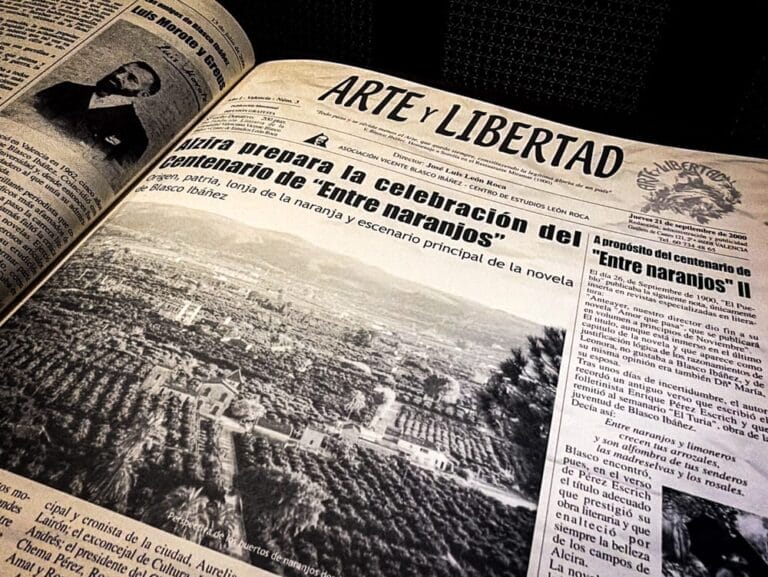 Archival photograph of an open newspaper spread titled Arte y Libertad, showing headlines, articles, and historical photographs related to the commemoration of Vicente Blasco Ibáñez and events in Alzira, with dense columns of Spanish text and documentary imagery, preserved in a university archive focused on the cultural legacy of Vicente Blasco Ibáñez and Vicente Blasco Ibanez in journalism and public memory.