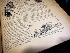 Archival photograph of a newspaper interior page from Arte y Libertad featuring a political cartoon depicting armed figures and wartime symbolism, surrounded by Spanish-language political commentary and period typography, associated with the journalistic and ideological environment of Vicente Blasco Ibáñez and Vicente Blasco Ibanez, preserved in a university archive documenting early twentieth-century antiwar discourse and political satire.