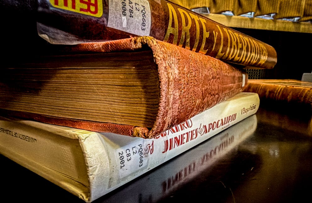 blasco ibáñez library: close-up of worn Spanish books stacked with call-number labels and a gilded spine